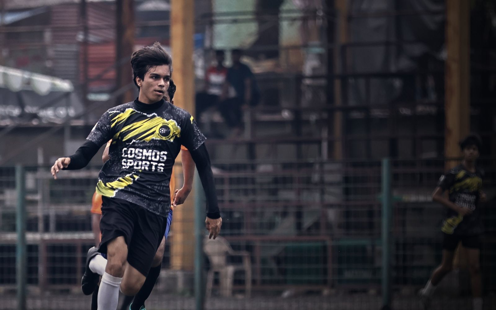 A Cosmos senior player on the ball under the lights