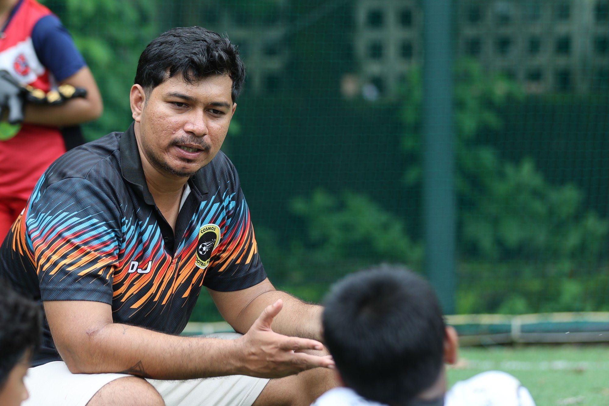 Deepak Joshi talking to a player on the sideline