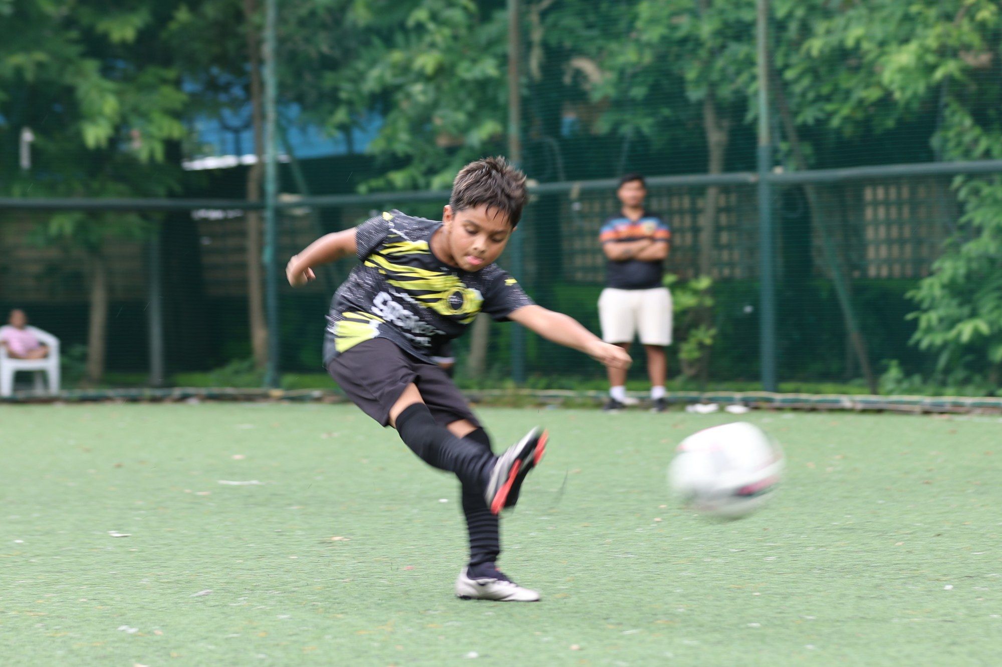 A player striking the ball across the turf