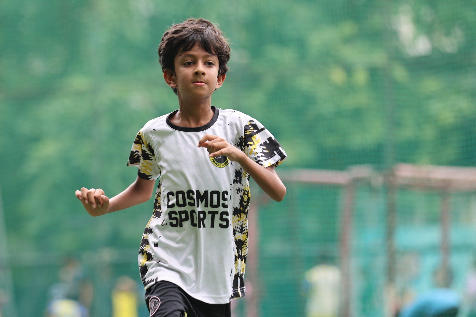 A player in the white Cosmos kit running
