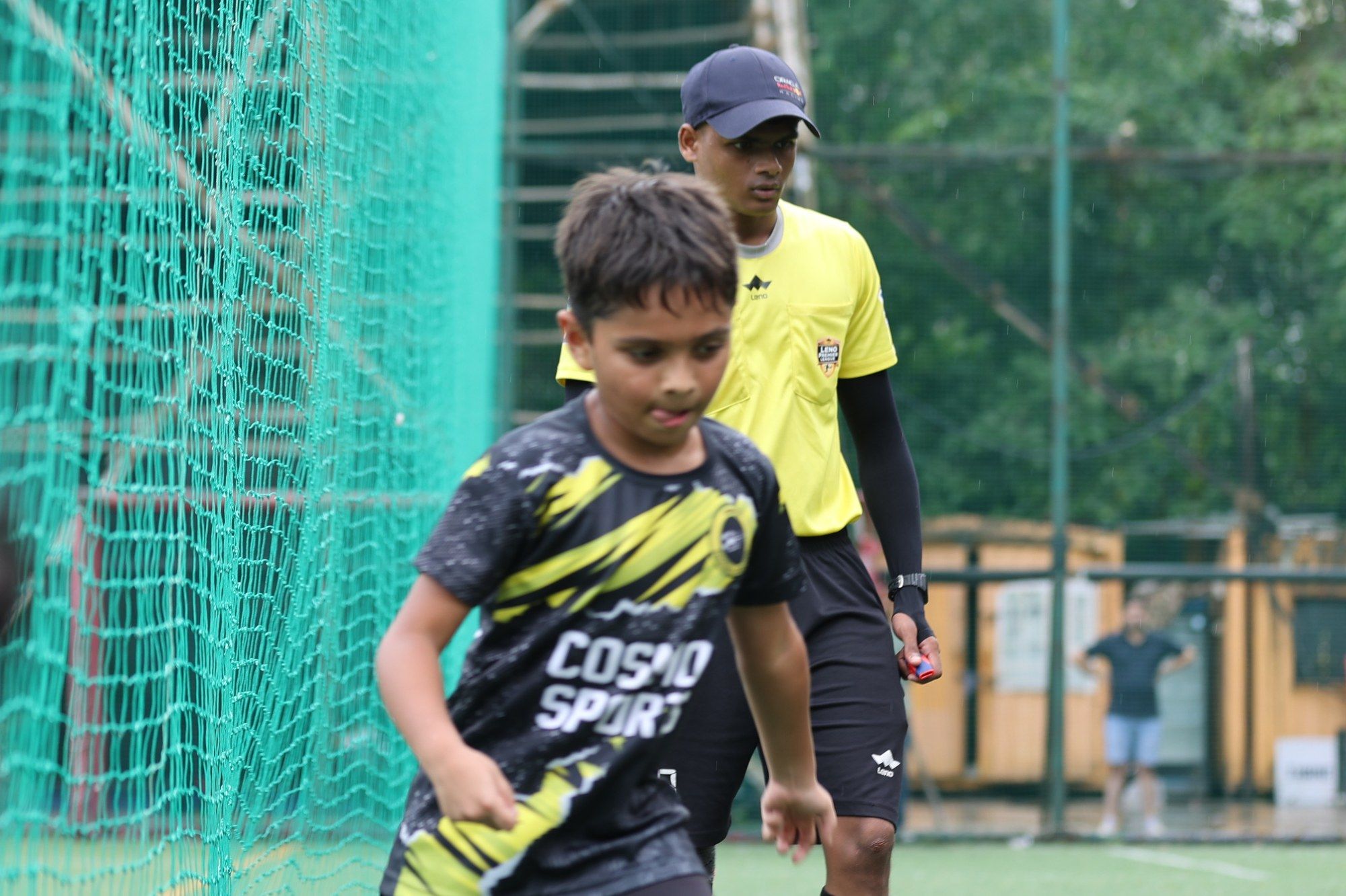 A young player in the black and yellow kit