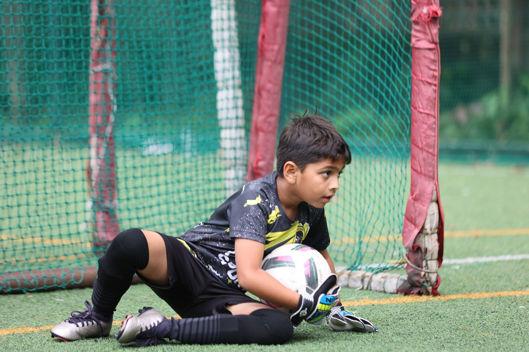 A goalkeeper on the ground after a save