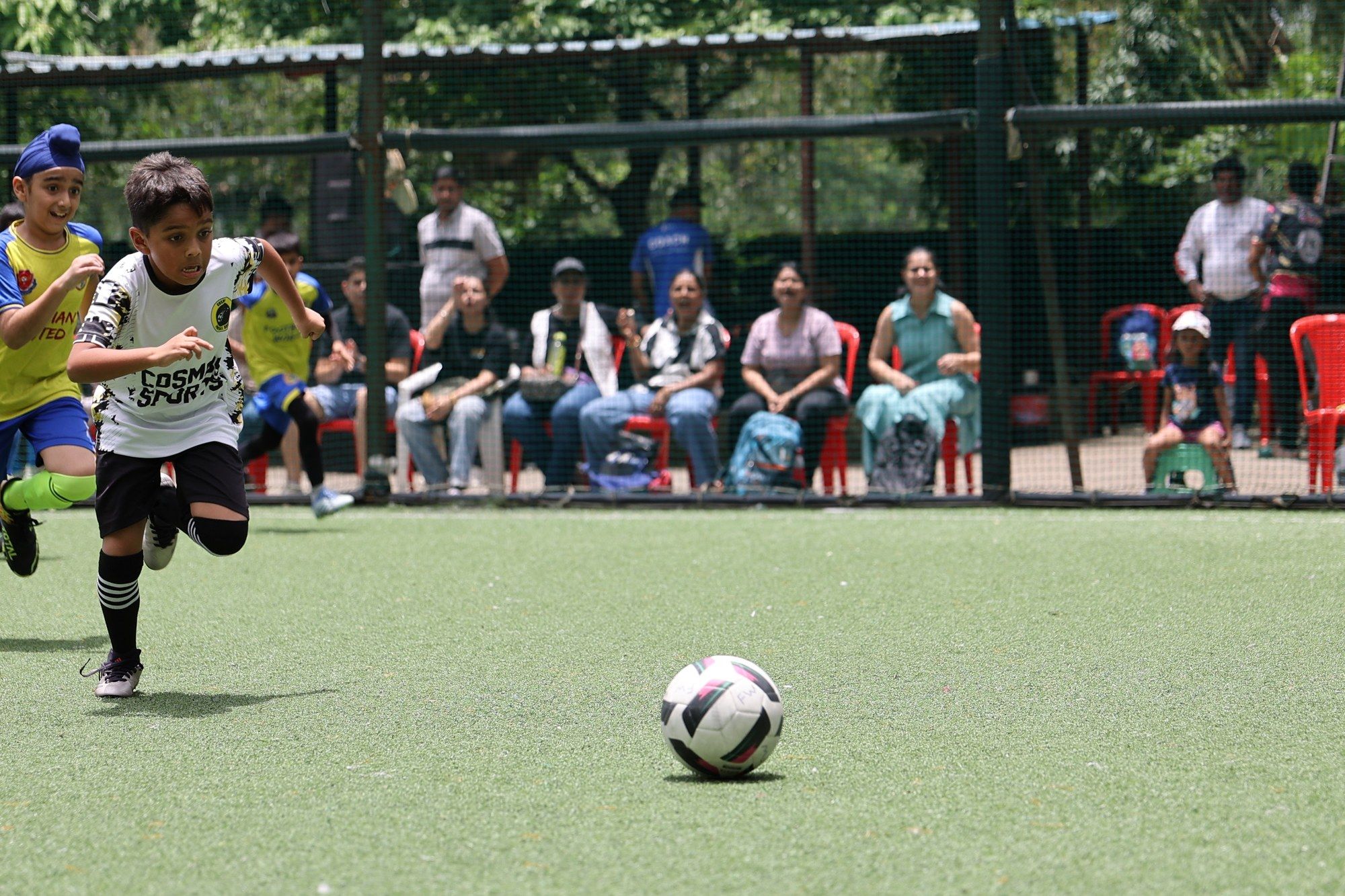 A player sprinting after the ball