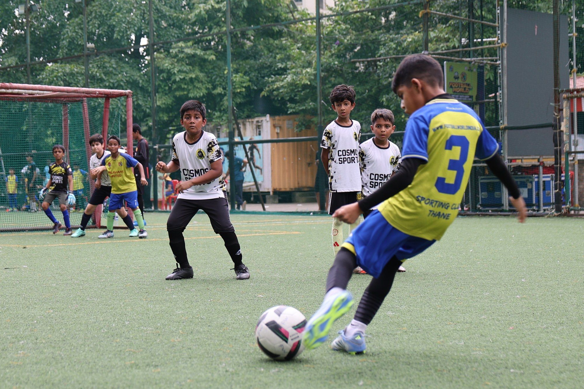 A player in yellow strikes the ball as a Cosmos player watches