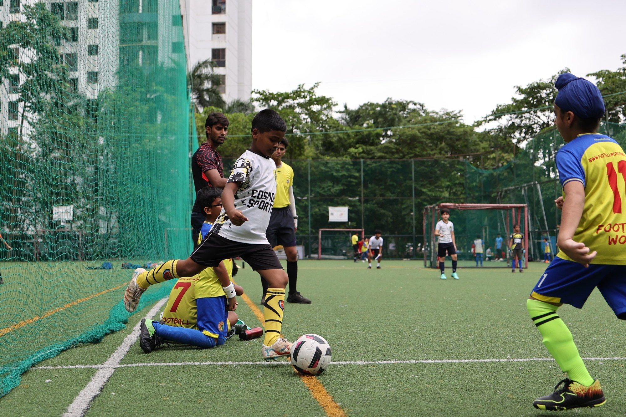 A player sliding in at the edge of the pitch