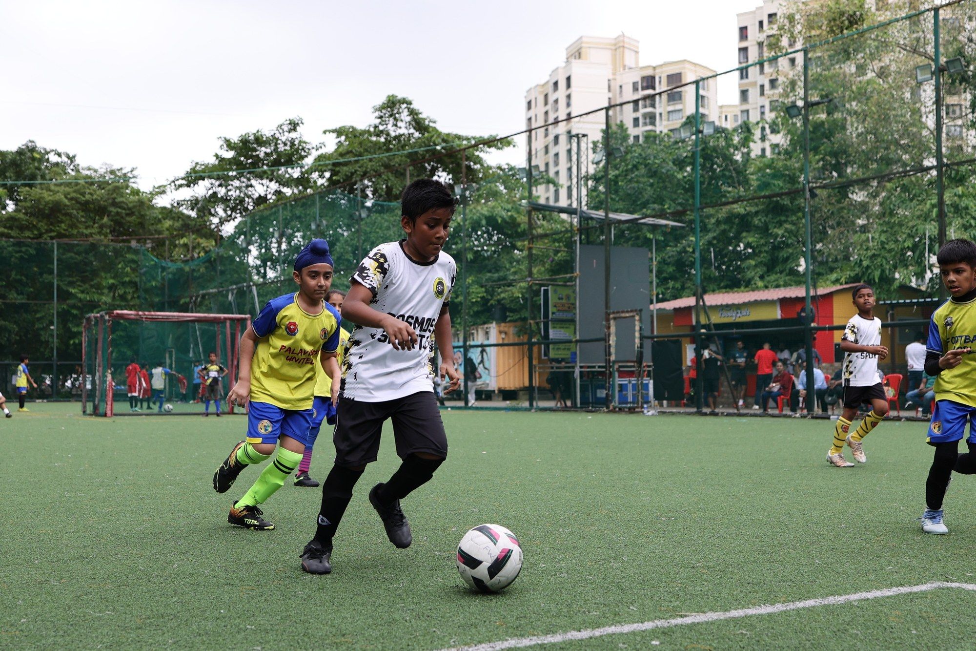 A player dribbling past a defender in yellow