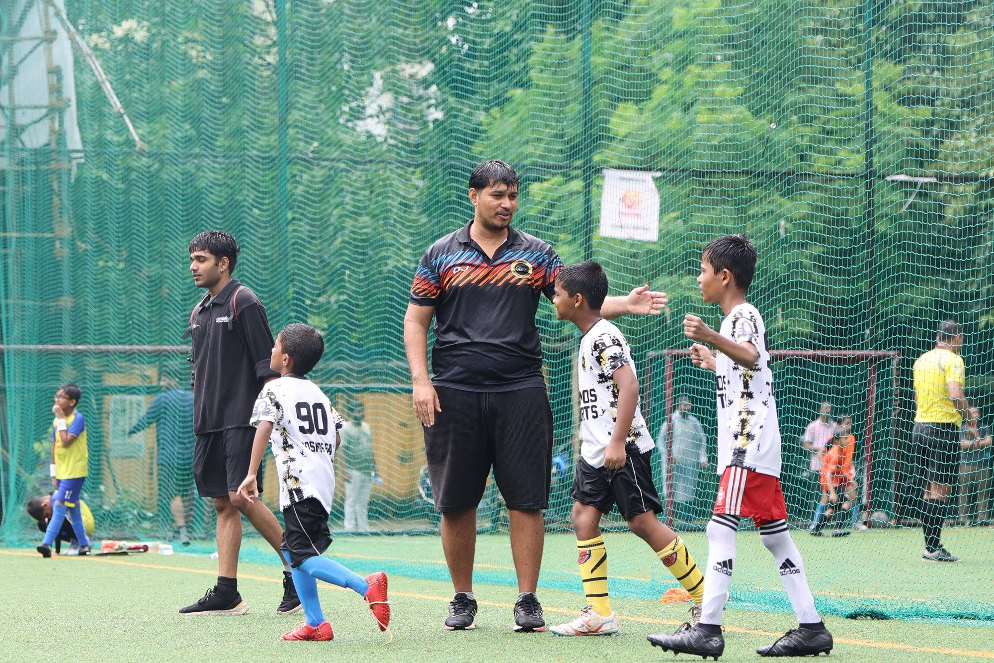 Deepak Joshi with players walking off the pitch