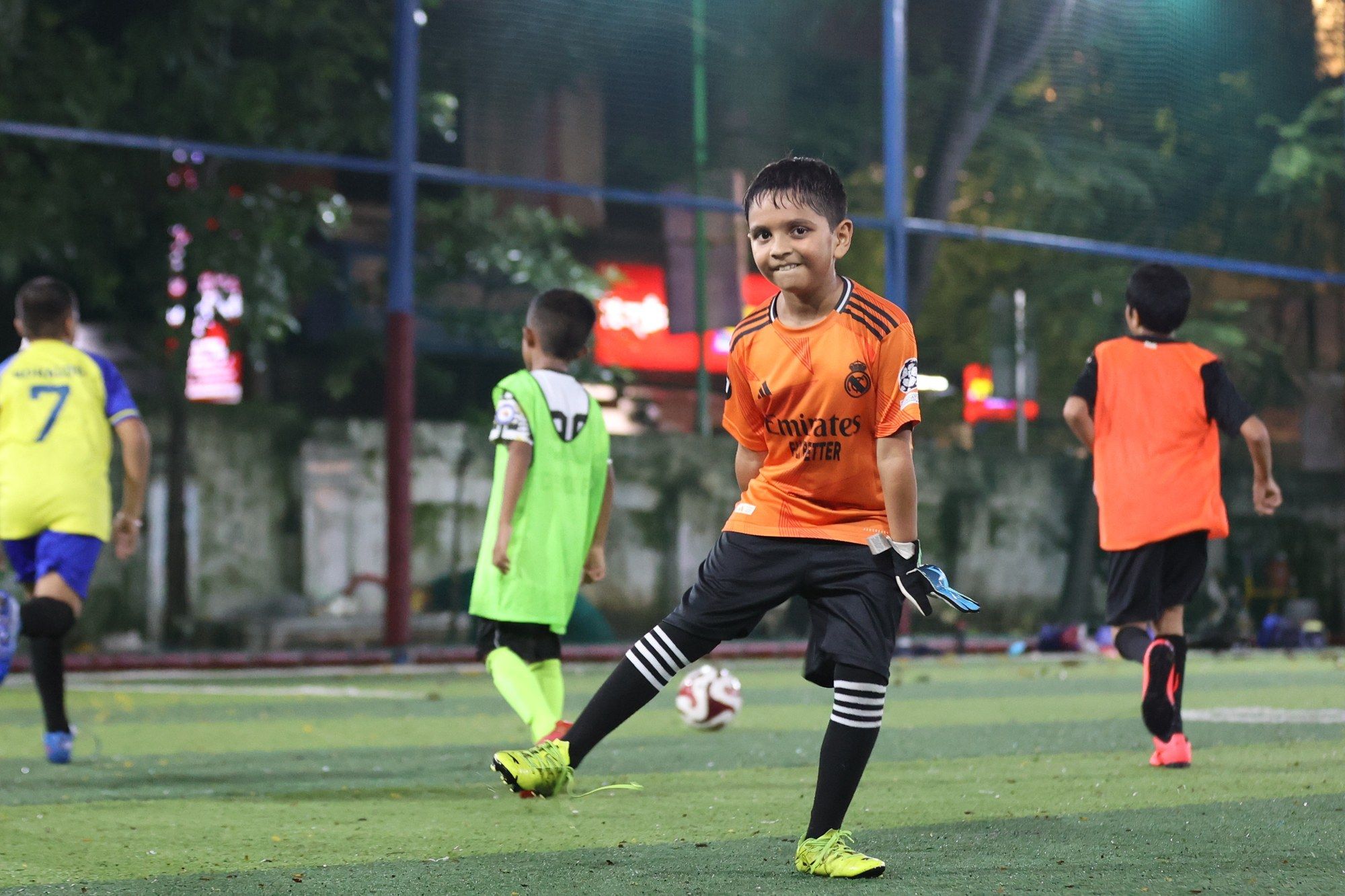 A goalkeeper in orange celebrating at training