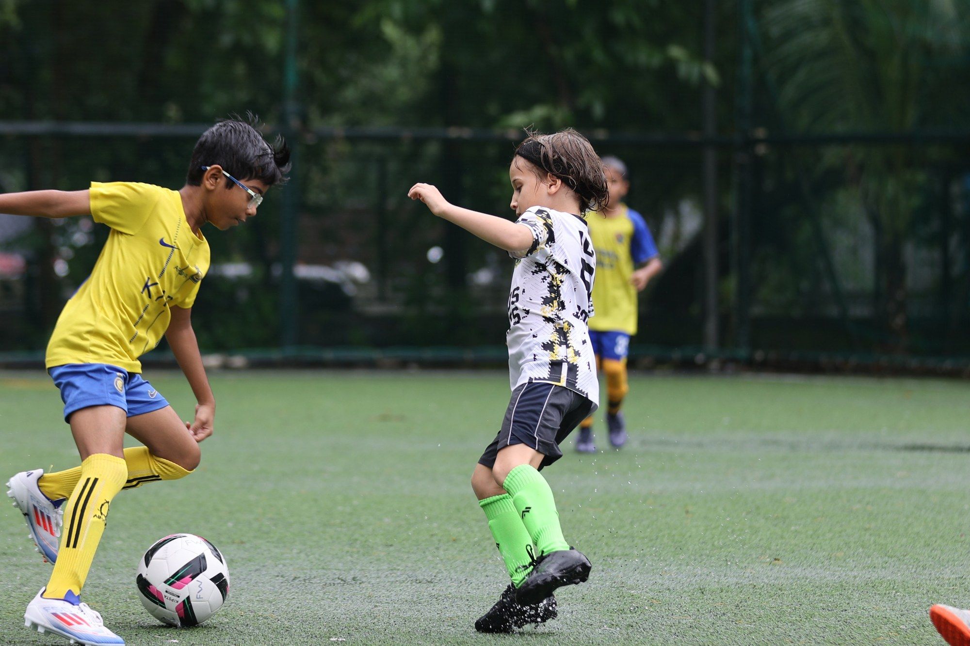 A Cosmos player and an opponent in yellow go for the ball
