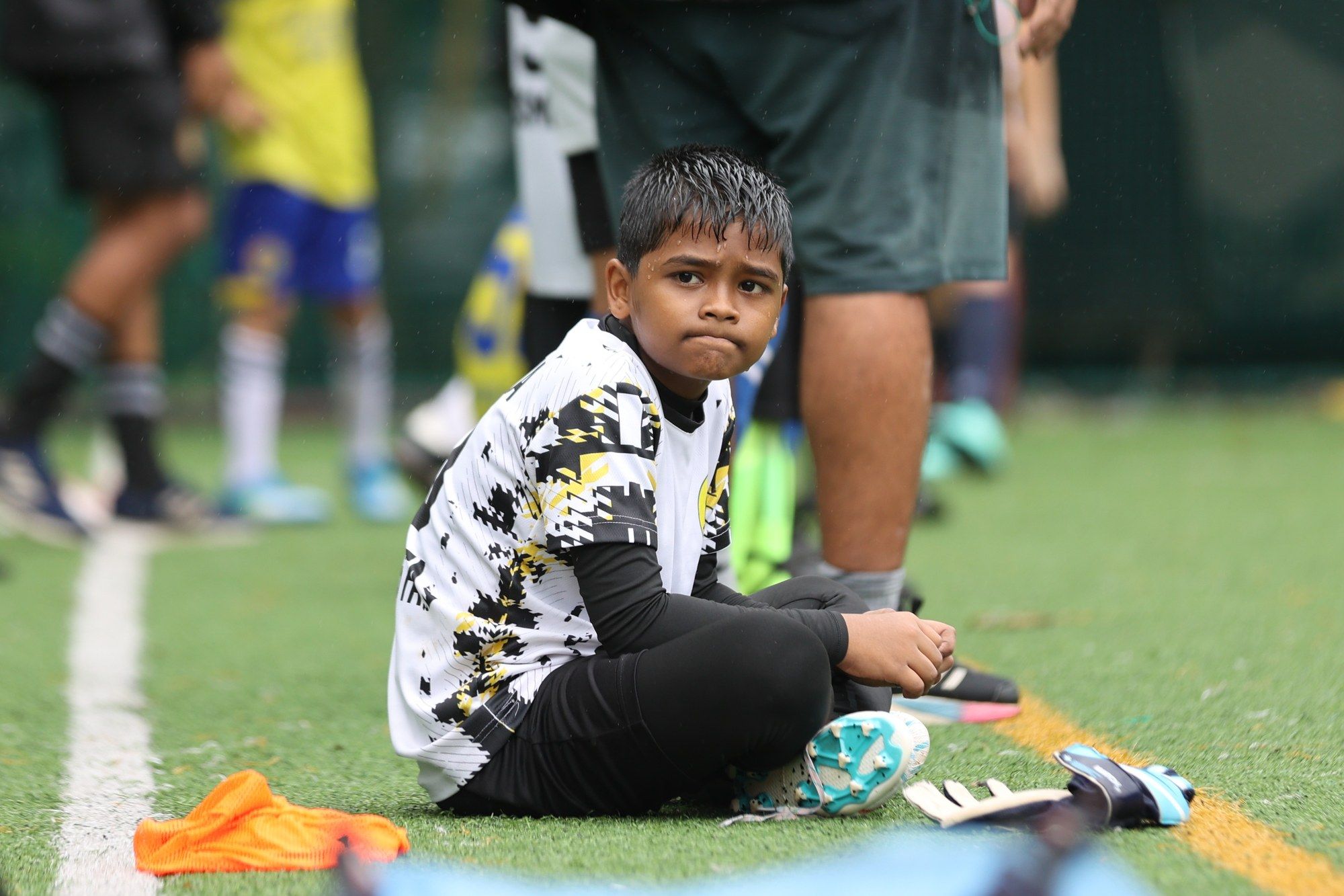 A player sitting on the turf, looking up