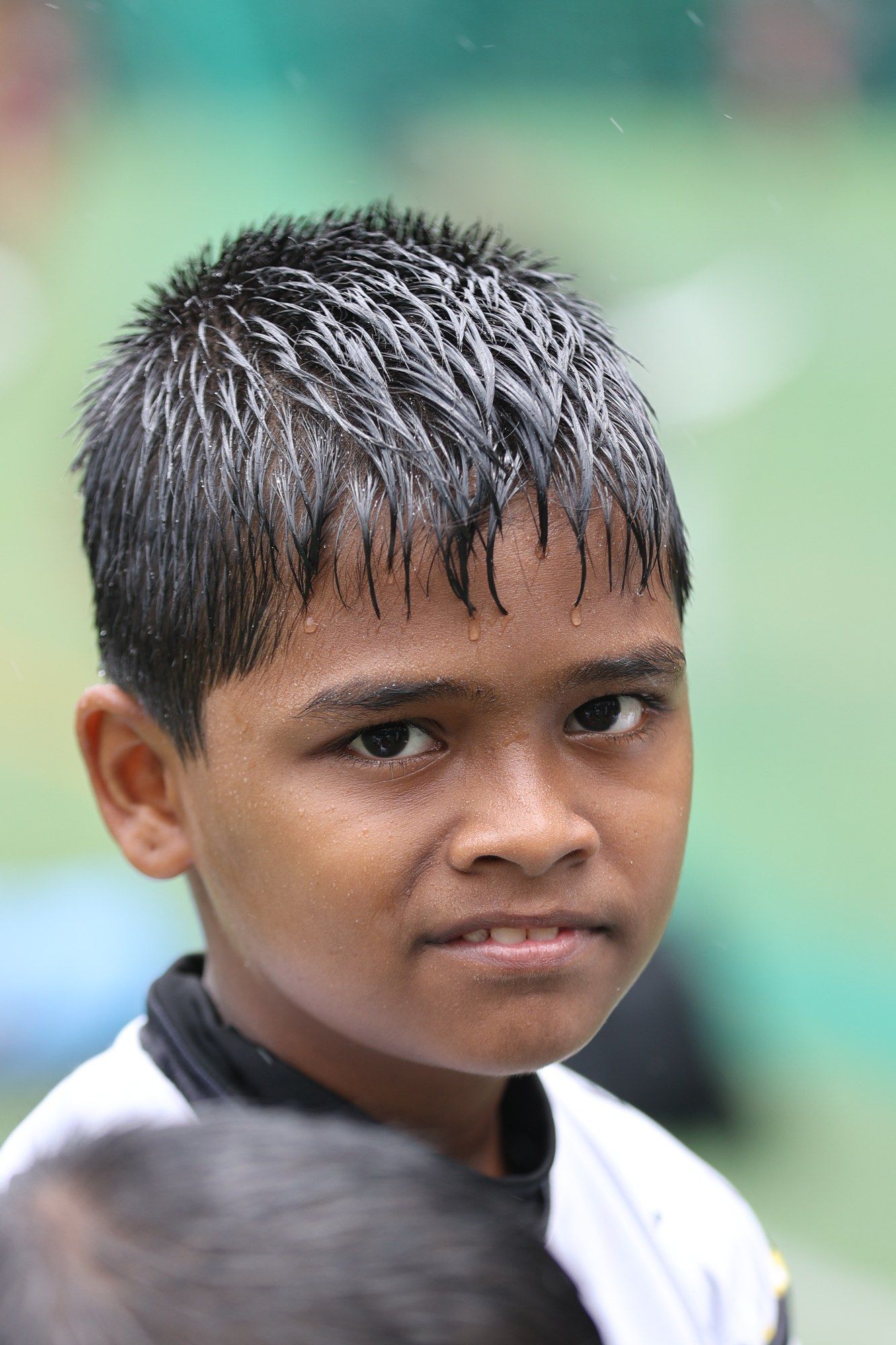 A soaked player smiling at the camera