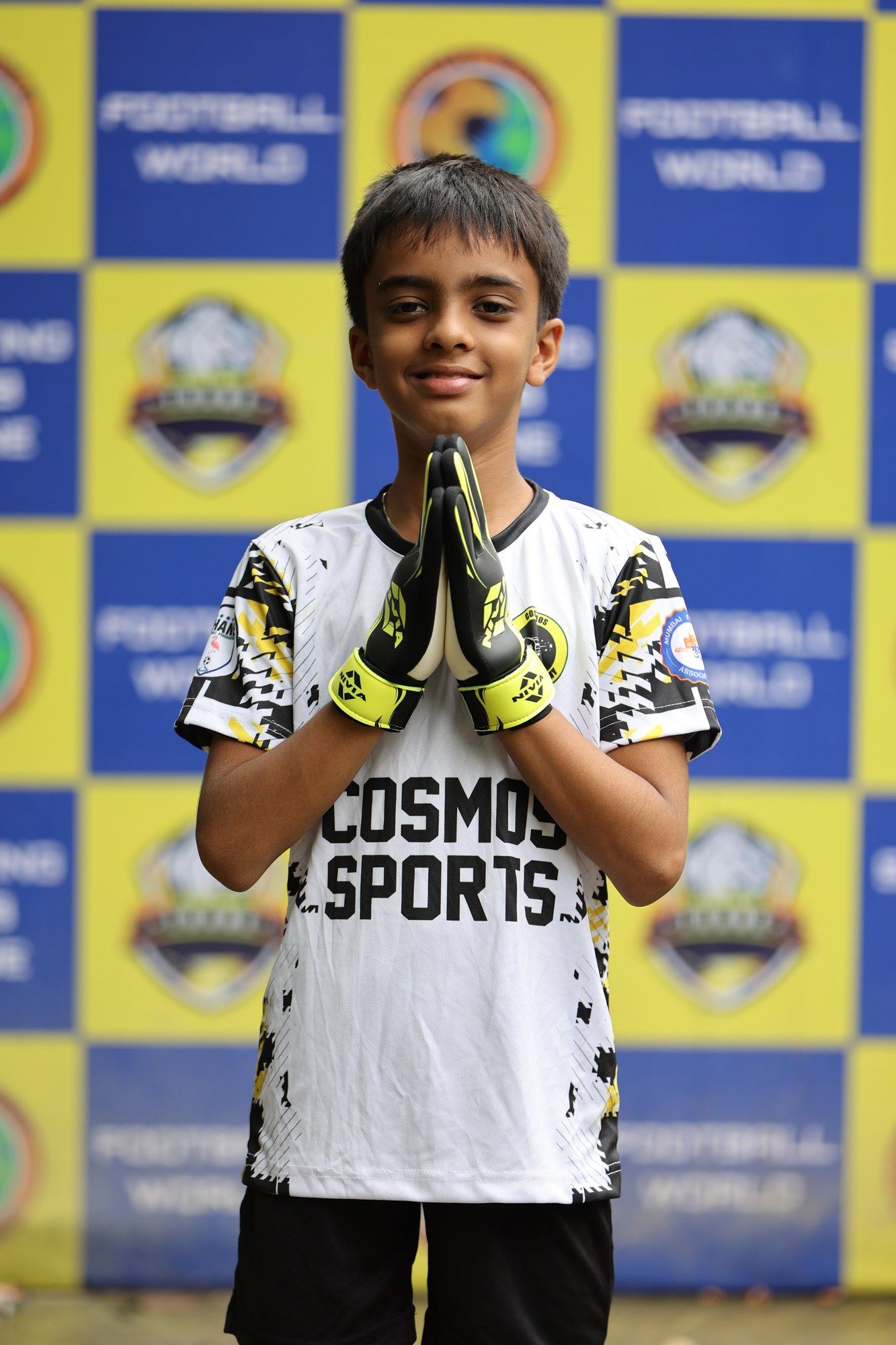 A goalkeeper pressing gloves together on picture day