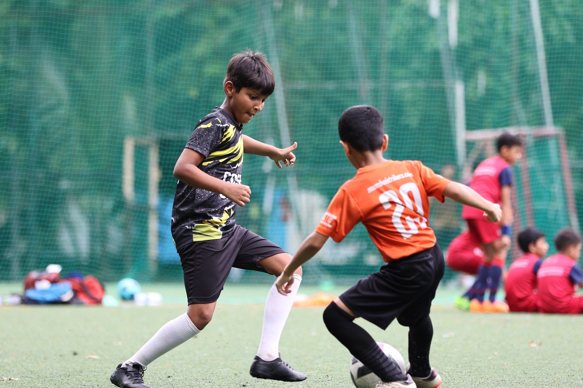 A Cosmos player and an opponent in orange tussle for the ball