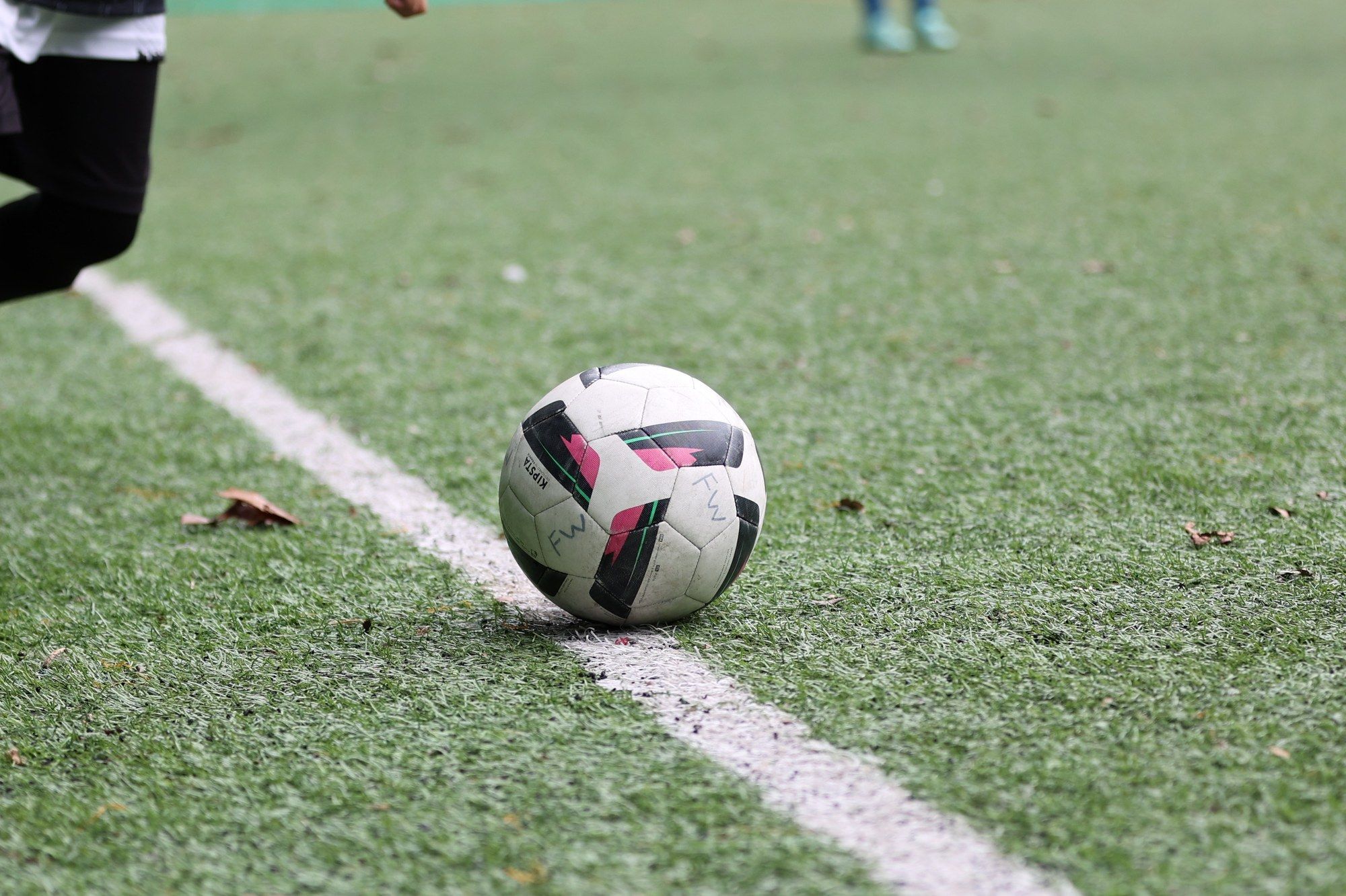 The ball sitting on the white line