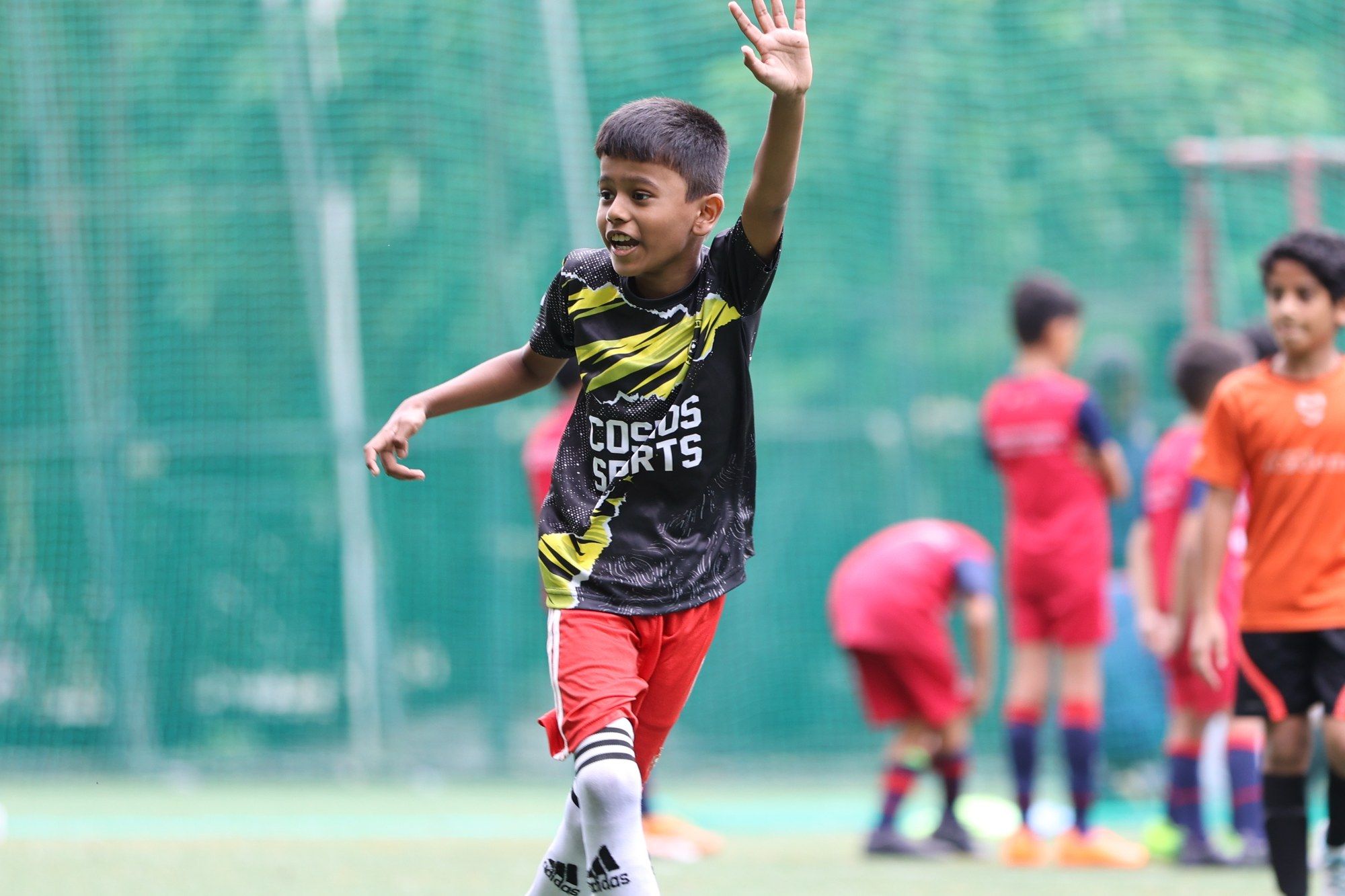 A player raising an arm to call for the ball