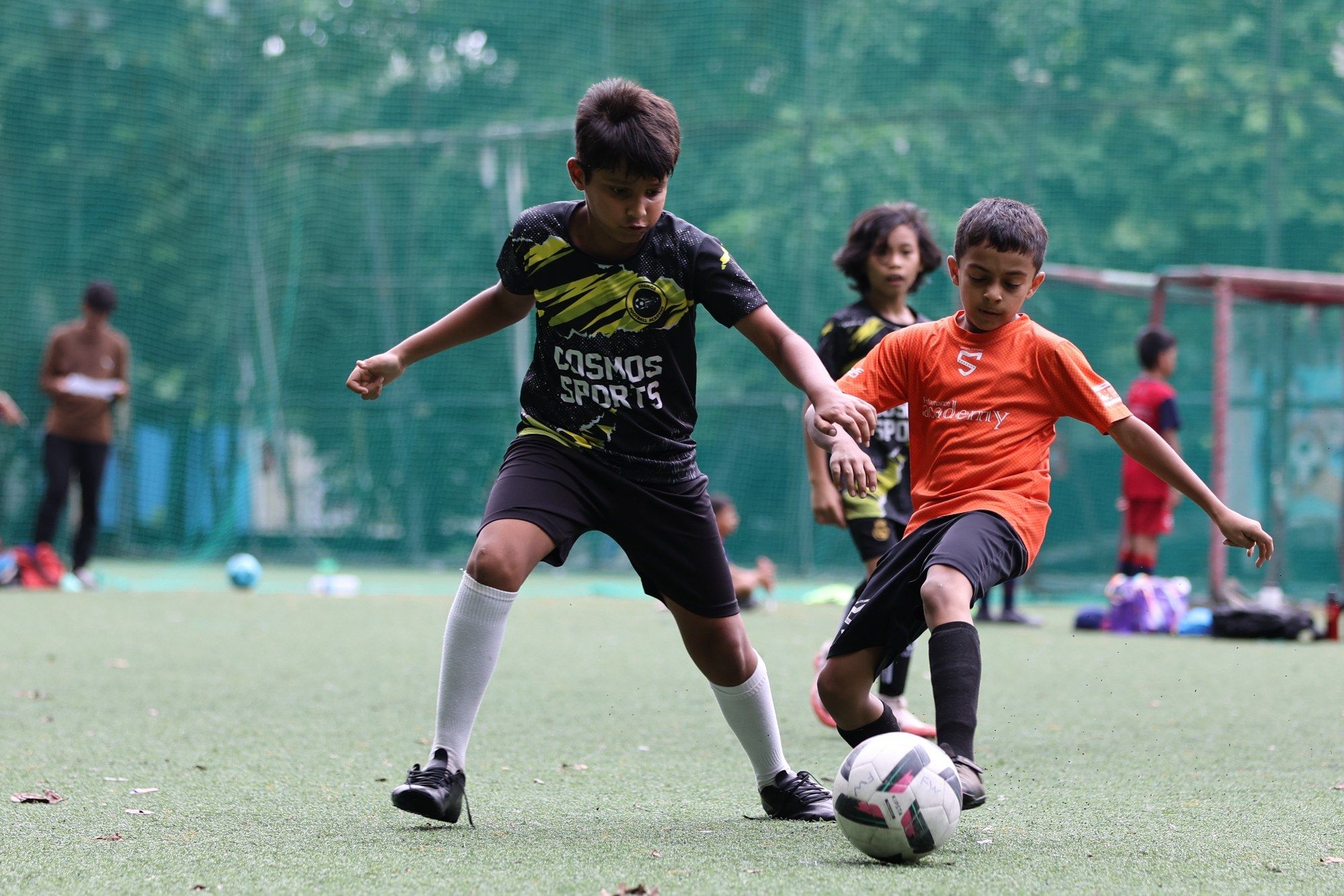 A player keeping the ball away from a defender