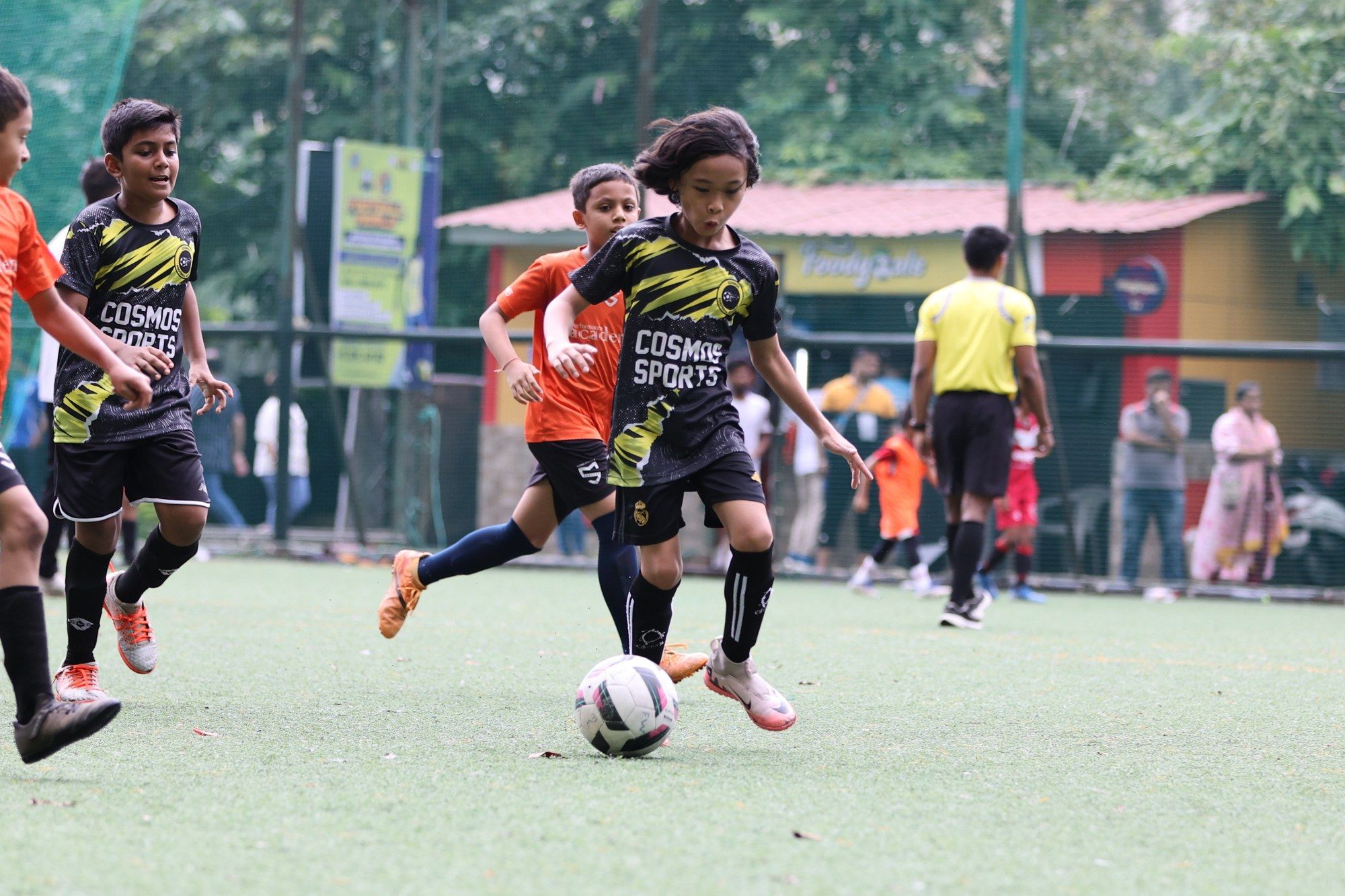 A Cosmos player with long hair on the ball