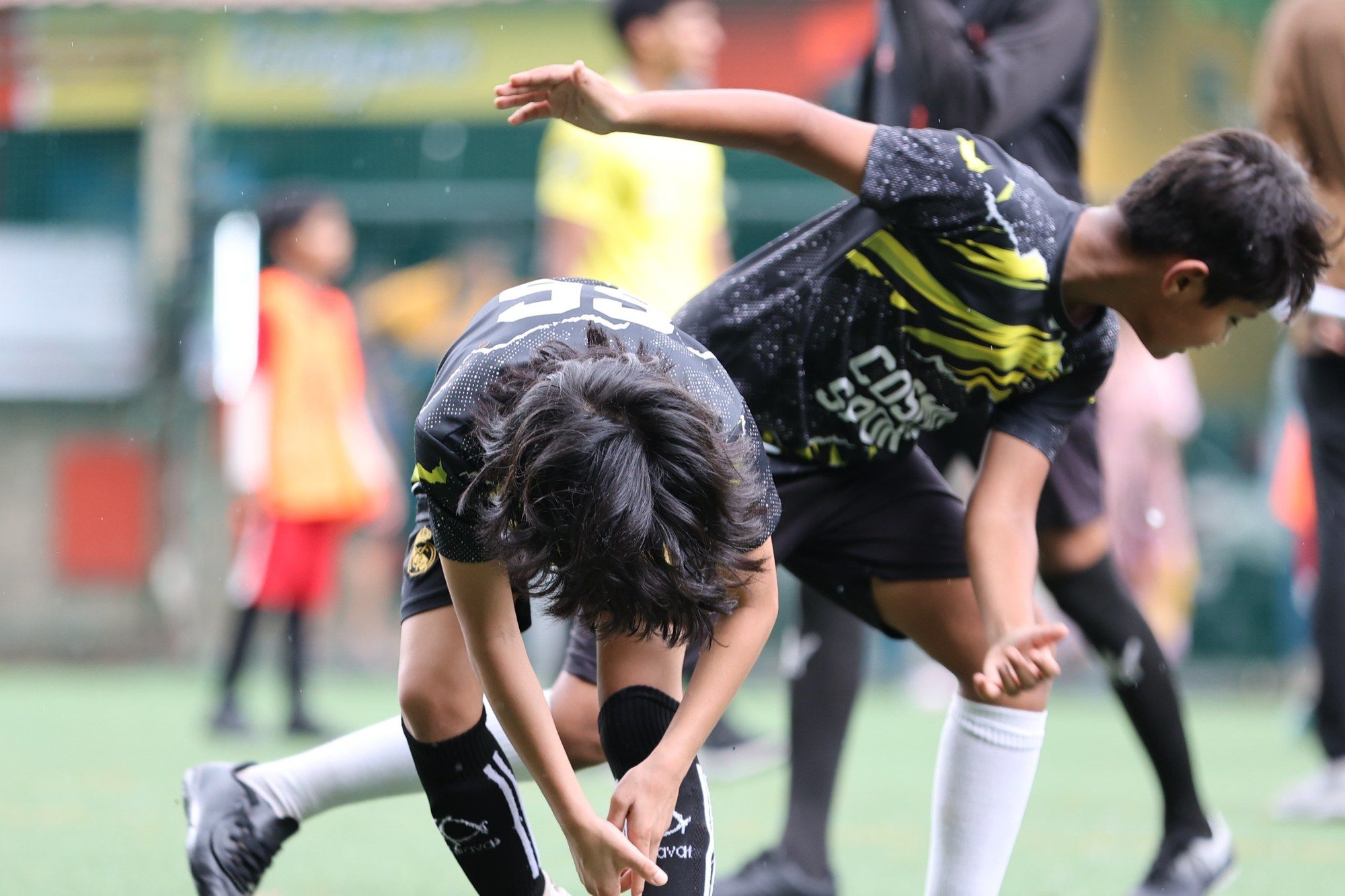 Players with hands on knees, catching their breath