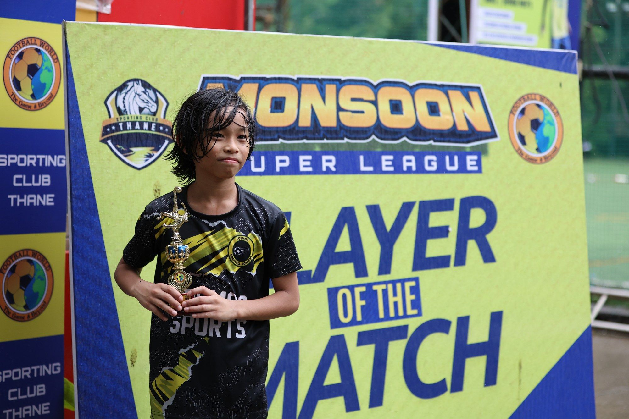 A Cosmos player in front of the Monsoon Super League Player of the Match board